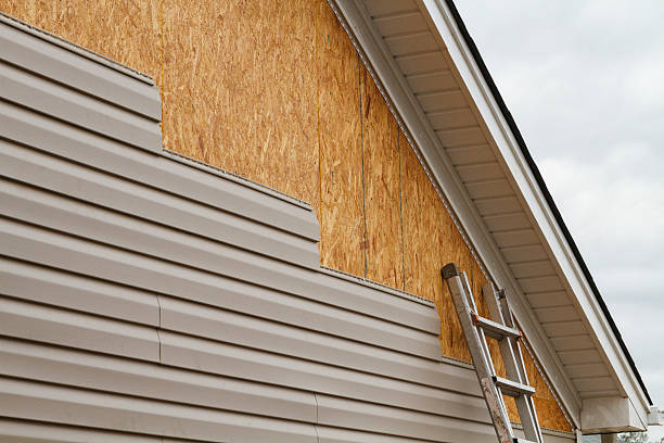 Professional Storm Damage Siding Repair technician working in Millmont, PA